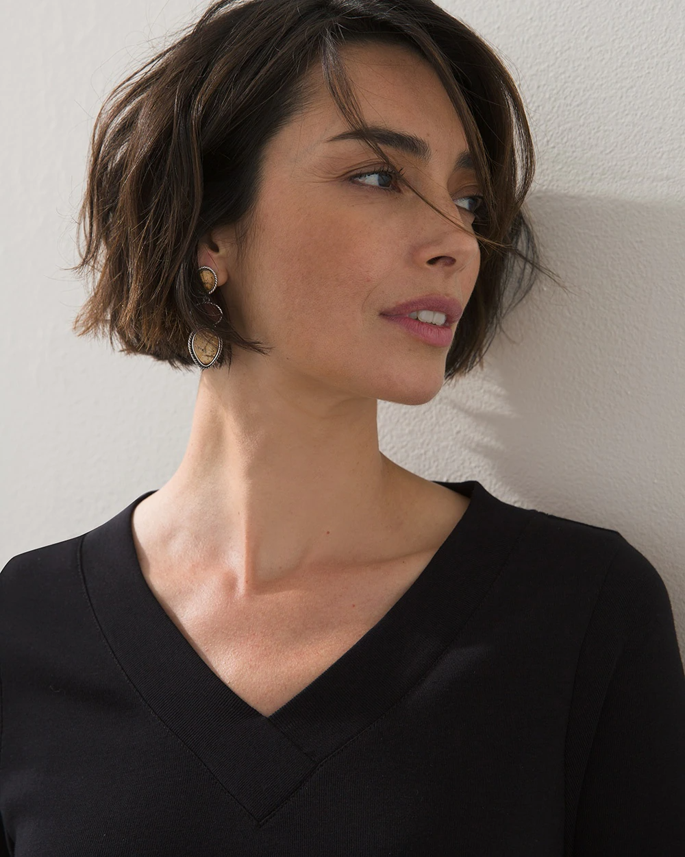 A woman with a chic, eye-catching Korean-inspired bob hairstyle, showcasing modern elegance in well-lit, colorful styling that emphasizes individuality.