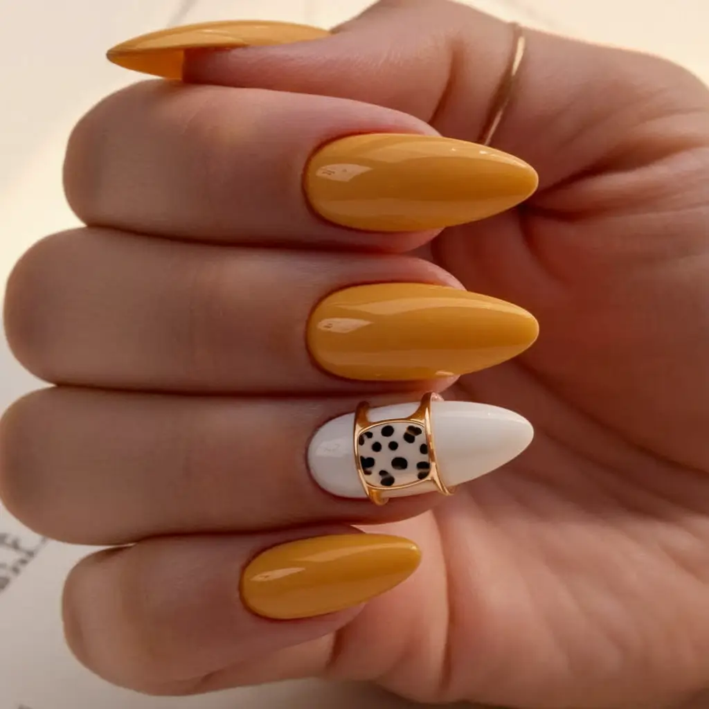 nail trends for fall 2025 Golden Mustard and Dalmatian Accent Almond Nails