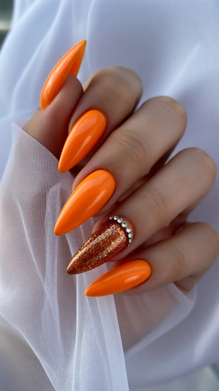 Elegant almond nails 2026 Vibrant Orange Glamour with Sparkling Accents
