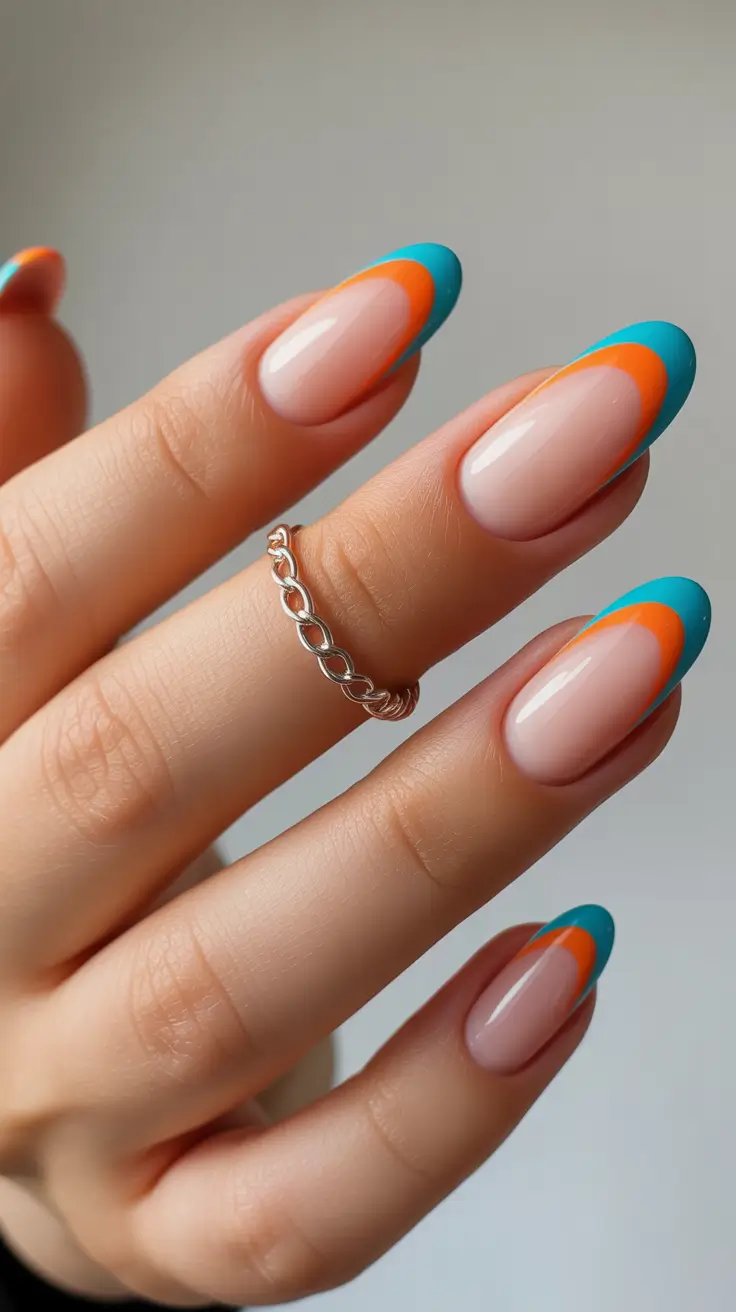 nail colors ideas for 2026 Dual-Tone French Waves in Teal and Tangerine