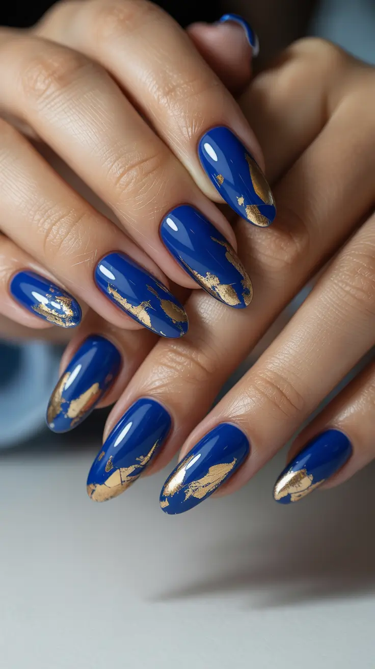 February nails designs 2026 Royal Blue Almond Nails With Gold Foil Accents