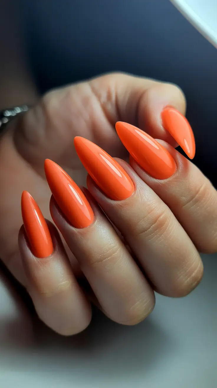vibrant spring break nails 2026 Neon Coral Stiletto