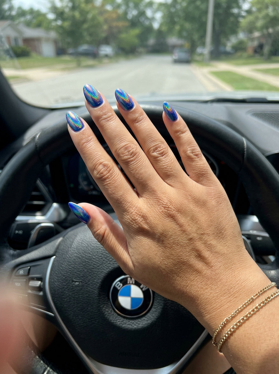 Cobalt Blue Chrome Swirls 2026: Futuristic Festival Nails Cobalt blue holographic chrome swirl nails for colourful summer nails 2026 festivals or night out. Edgy and futuristic.