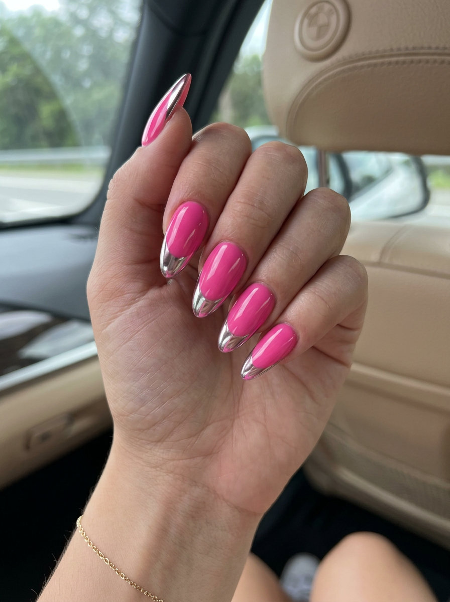 Futuristic Pink Chrome Almond Nails 2026 Futuristic hot pink almond nails with silver chrome French tips for parties, a bold colourful summer nails 2026 look.