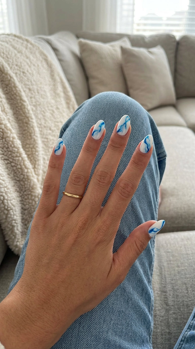 Fun Summer Nails 2026: Coastal Cerulean Marble Chic Event Fun summer nails 2026: Coastal Cerulean Marble oval nails with blue and white veining for events.
