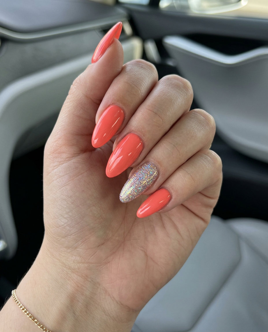 Coral holographic glitter accent almond nails for summer vacation and playful parties. June manicure ideas - summer trends 2026.