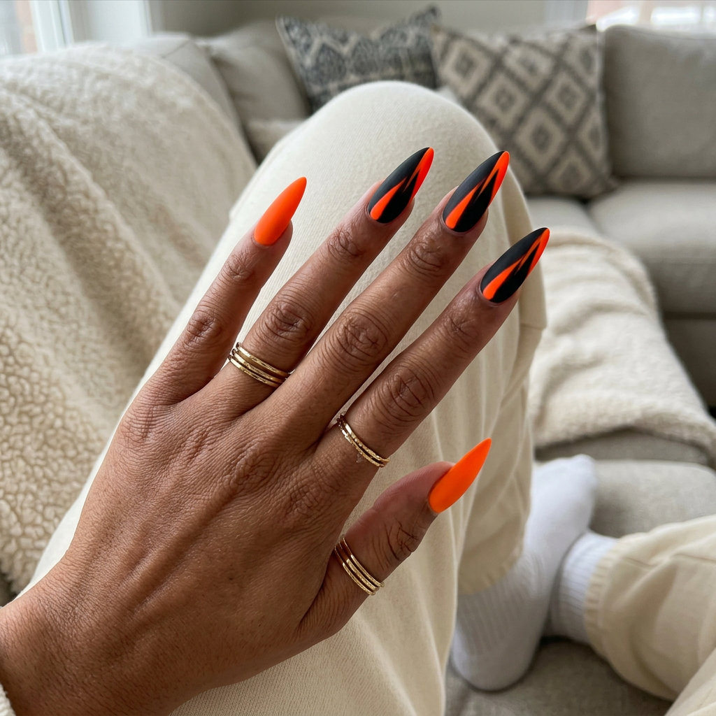 Vivid Orange Graphic Lines on Matte Black | Neon Summer Nails 2026 Vivid orange graphic lines on matte black for edgy festival style. Neon summer nails 2026.