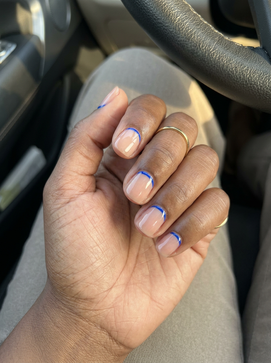 Electric line detail squoval nails for dark skin 2026. Minimalist, modern style with vivid cobalt blue accent line.