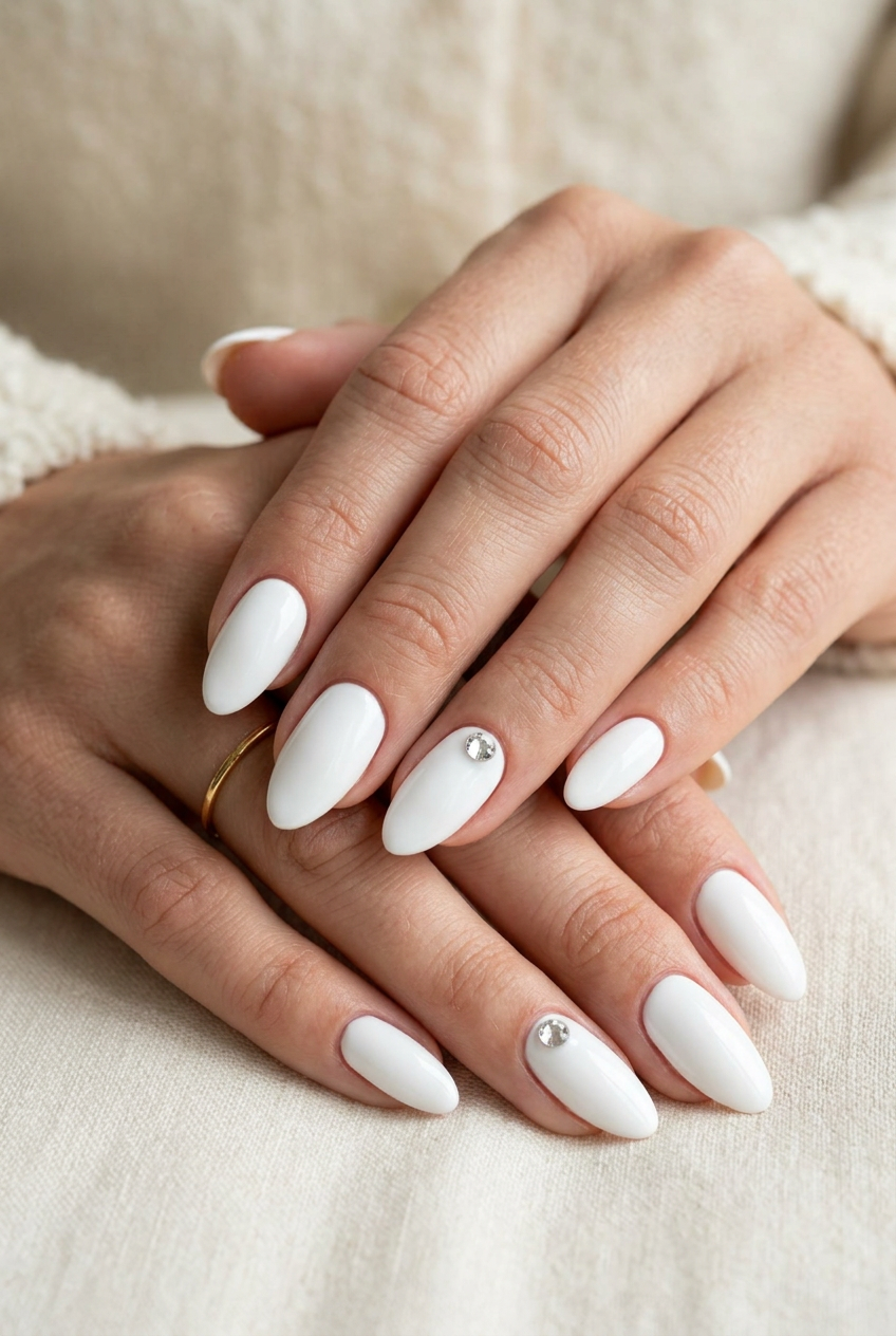 Sparkling White Gem Almond nails for almond summer nails 2026 for fair skin. Classic white with rhinestone accent.