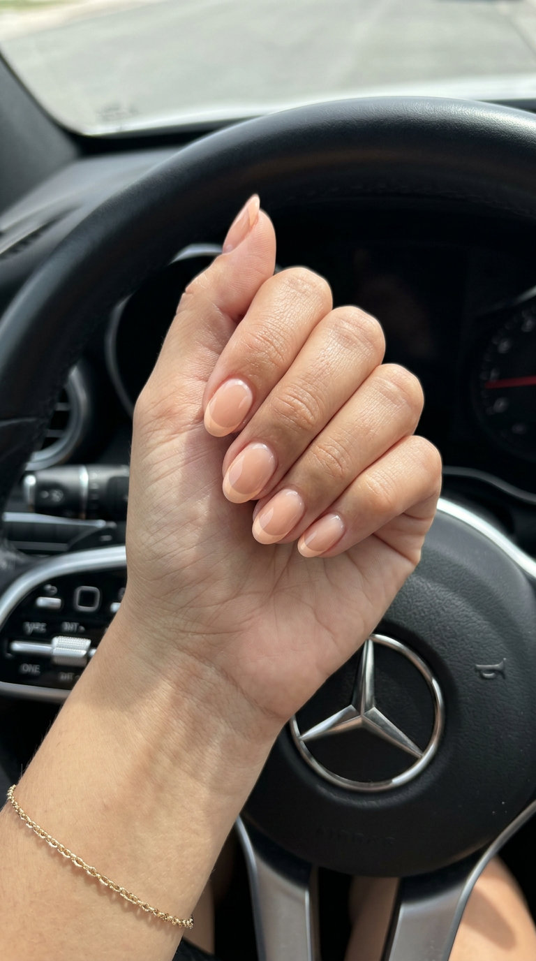 Short oval summer nails 2026 in light peach French tip glaze for wedding guest or bridal shower.