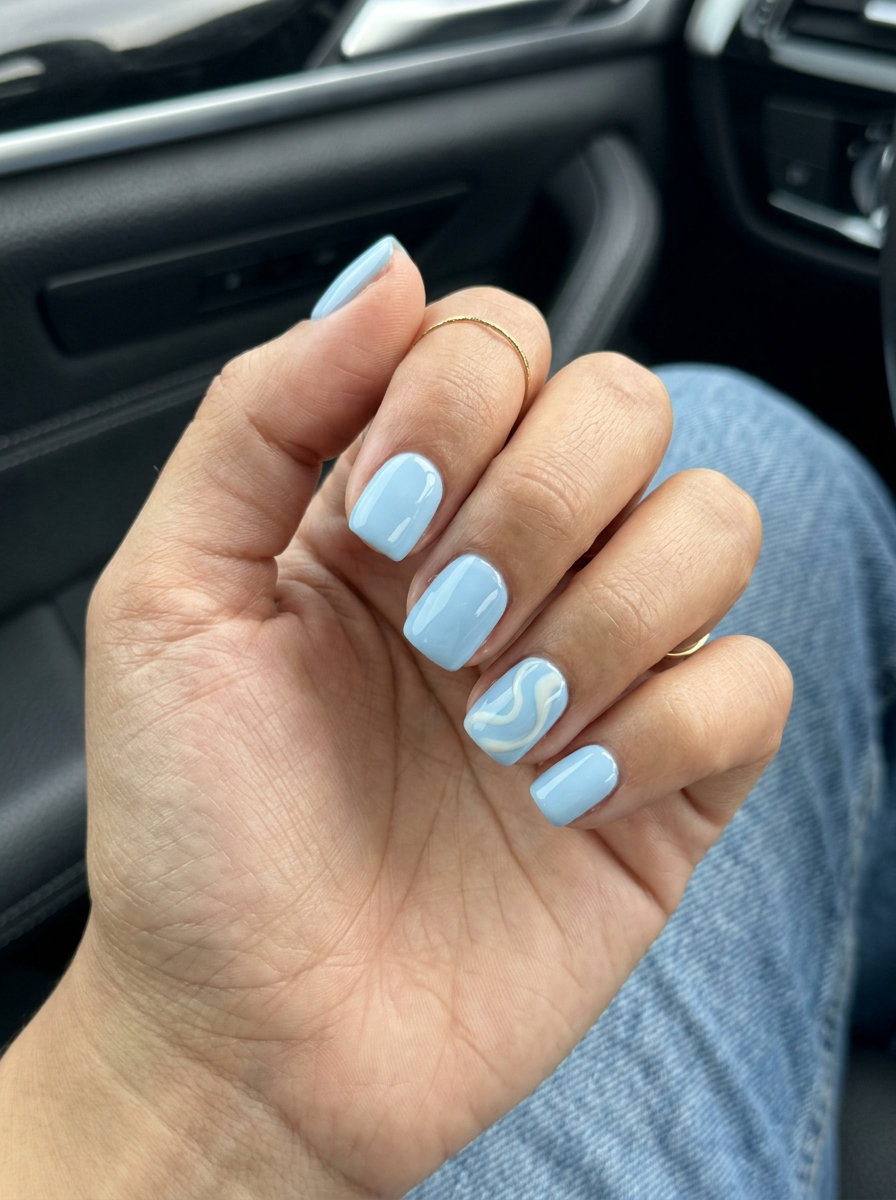 Simple Short Summer Nails 2026: Blue Swirl Accent Simple short summer nails 2026: Artistic Blue Swirl Accent gel polish for vacation.