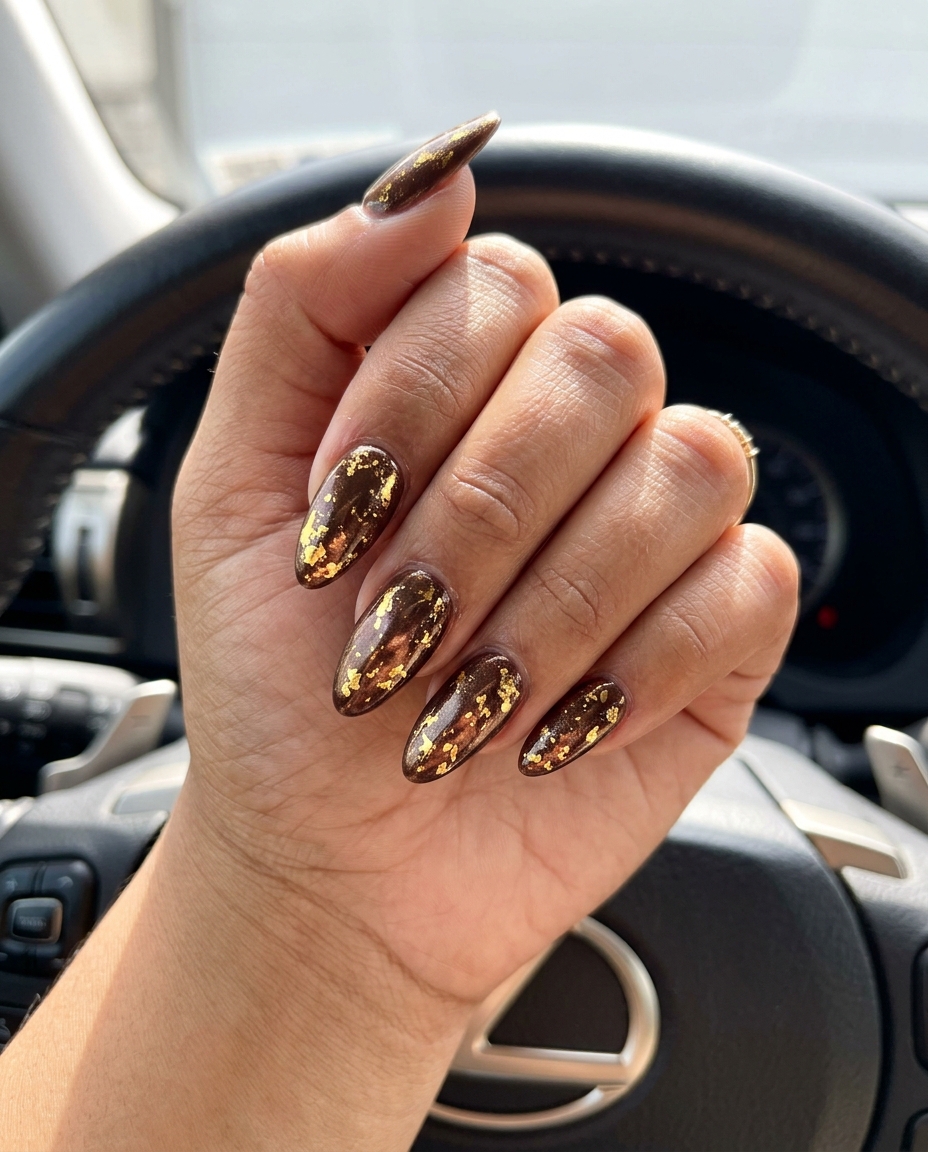 Gold Foil Flakes Almond Nails 2026 Metallic Gold Foil Flakes Long Almond nails for solid summer nails 2026. Luxurious & bold.