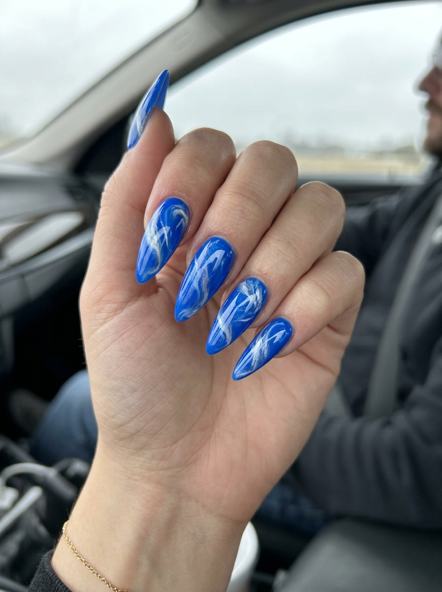 Electric blue stiletto marble swirl nails for stiletto summer nails 2026. Bold for parties.