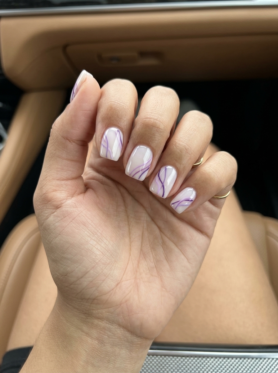 Summer colorful nails designs 2026: Lavender abstract lines on milky white base for bridal showers.