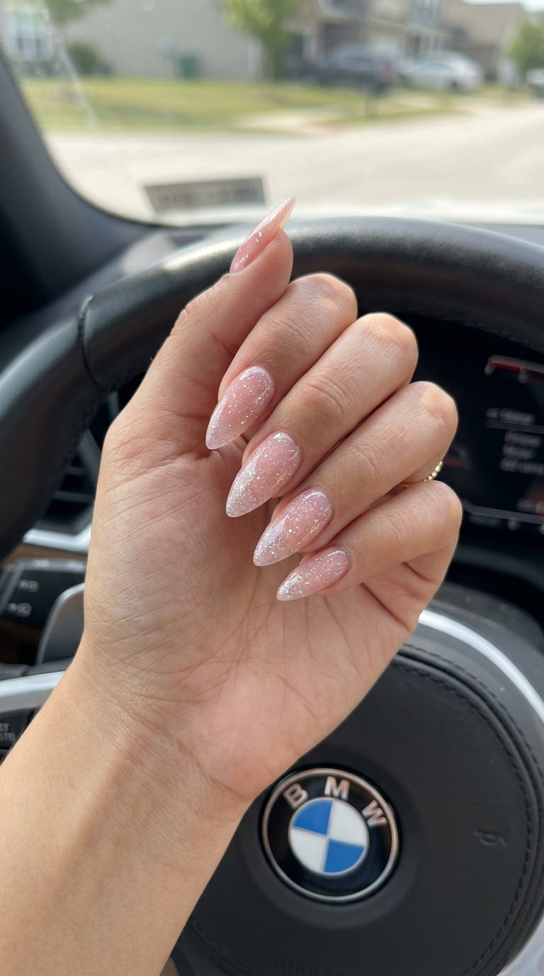 Blushing Glitter Jelly Almond nails for summer wedding 2026. Glamorous pale blush pink with holographic glitter.