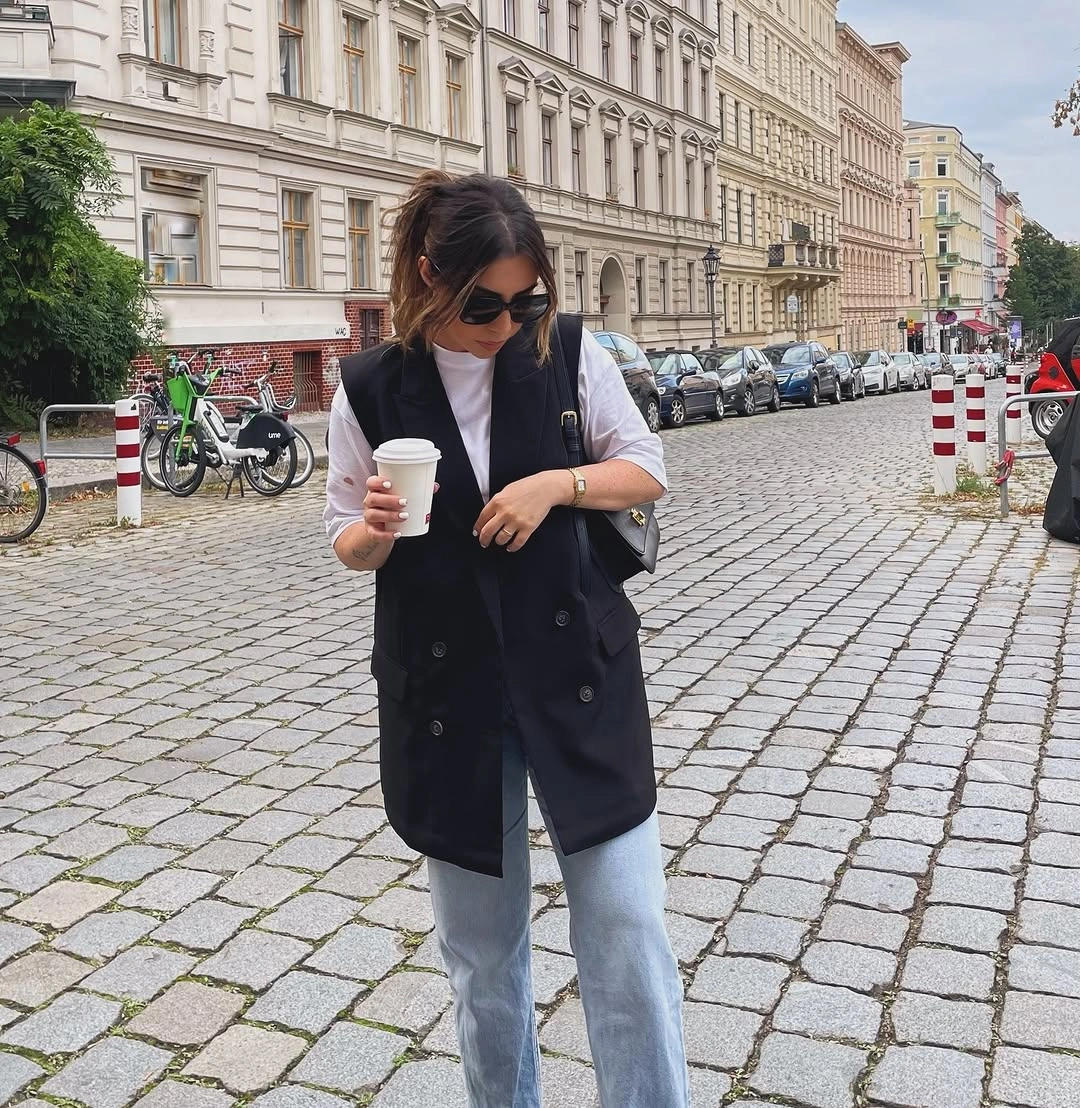 comfy fall outfits 2026 Black Vest, White Tee, And Light Jeans For City Errands