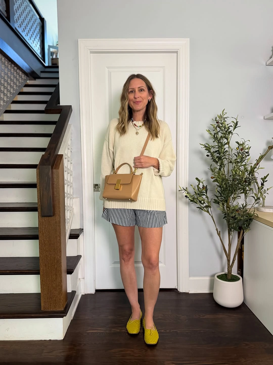 comfy fall outfits 2026 Cream Sweater And Striped Shorts For Warm Fall Ease
