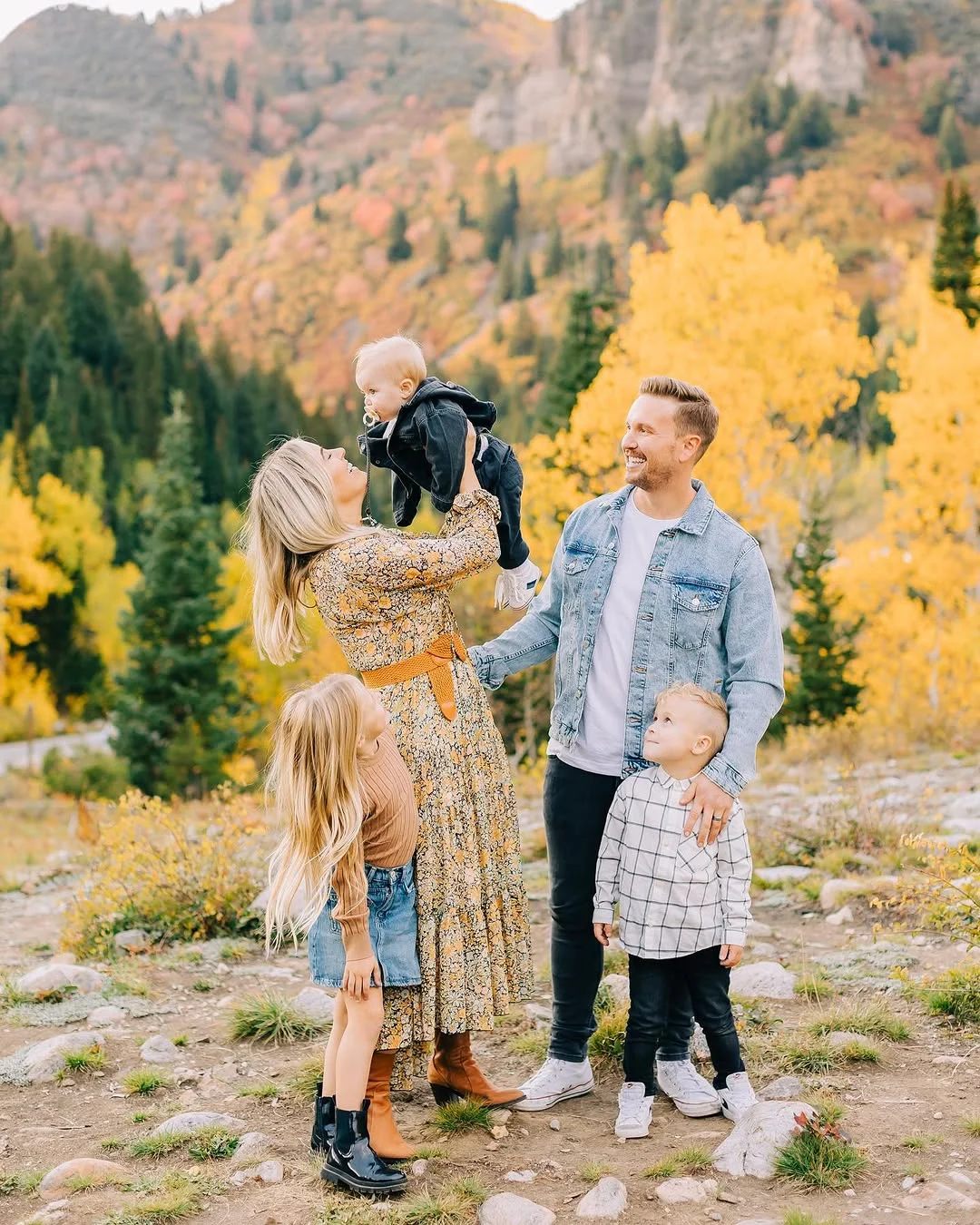 fall family picture outfits 2026 Golden Mountain Tones with Denim and Floral Layers
