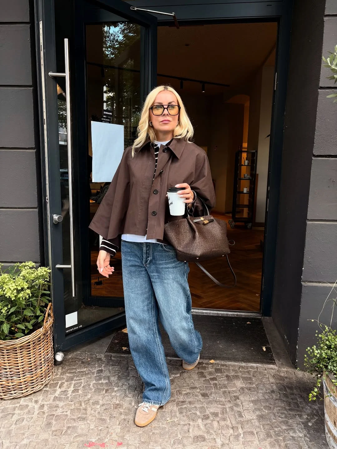 fall outfits with sneakers and jeans 2026 A Cropped Brown Jacket for Everyday City Style