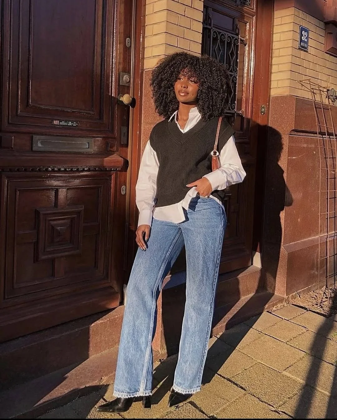 fall vest outfits for women 2026 The Black Sweater Vest and Blue Jean Combination That Never Fails