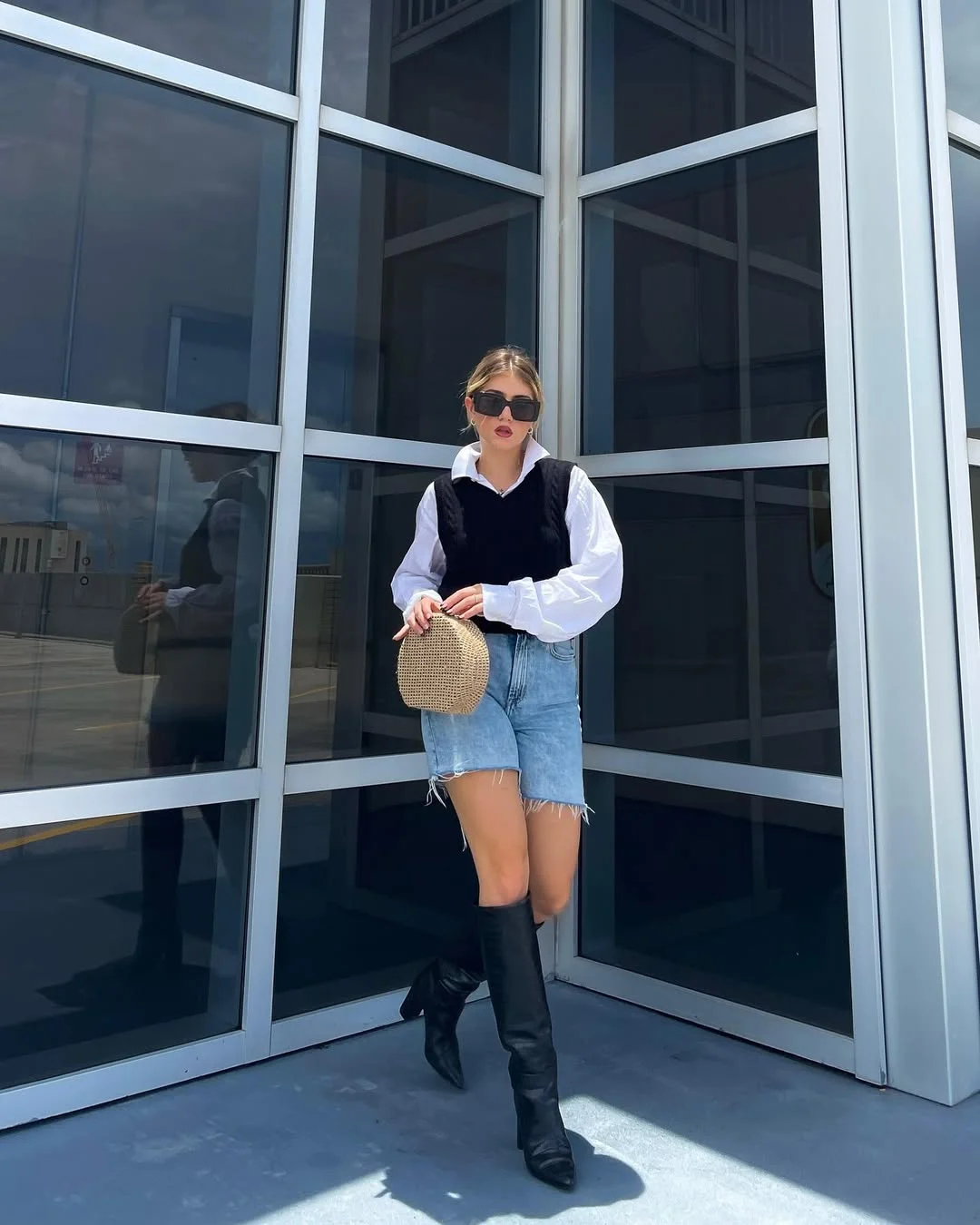 fall vest outfits for women 2026 The Black Sweater Vest With Denim Shorts and Tall Boots Contrast