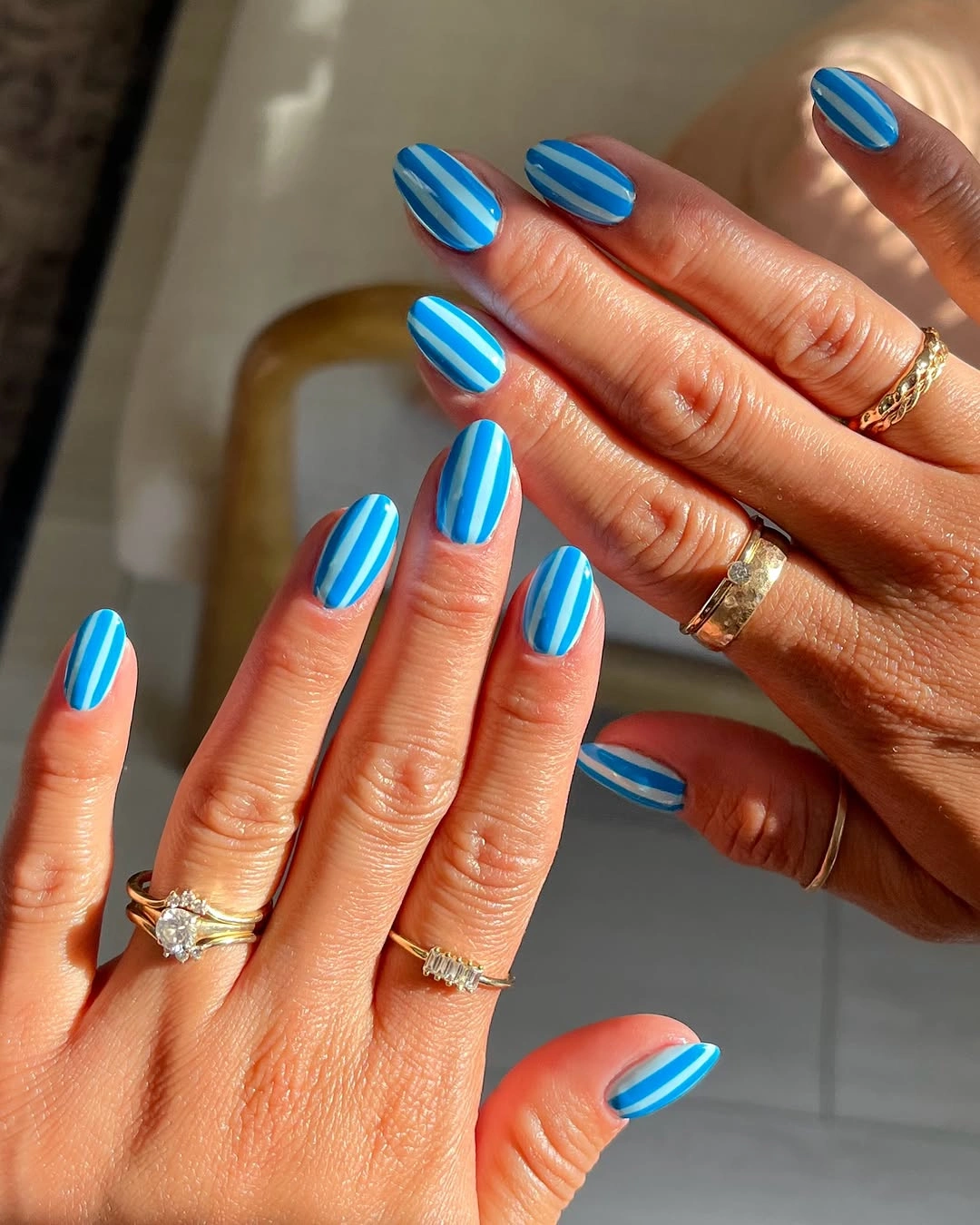august nails color 2026 Blue Striped Nails Inspired by Coastal Summer Escapes