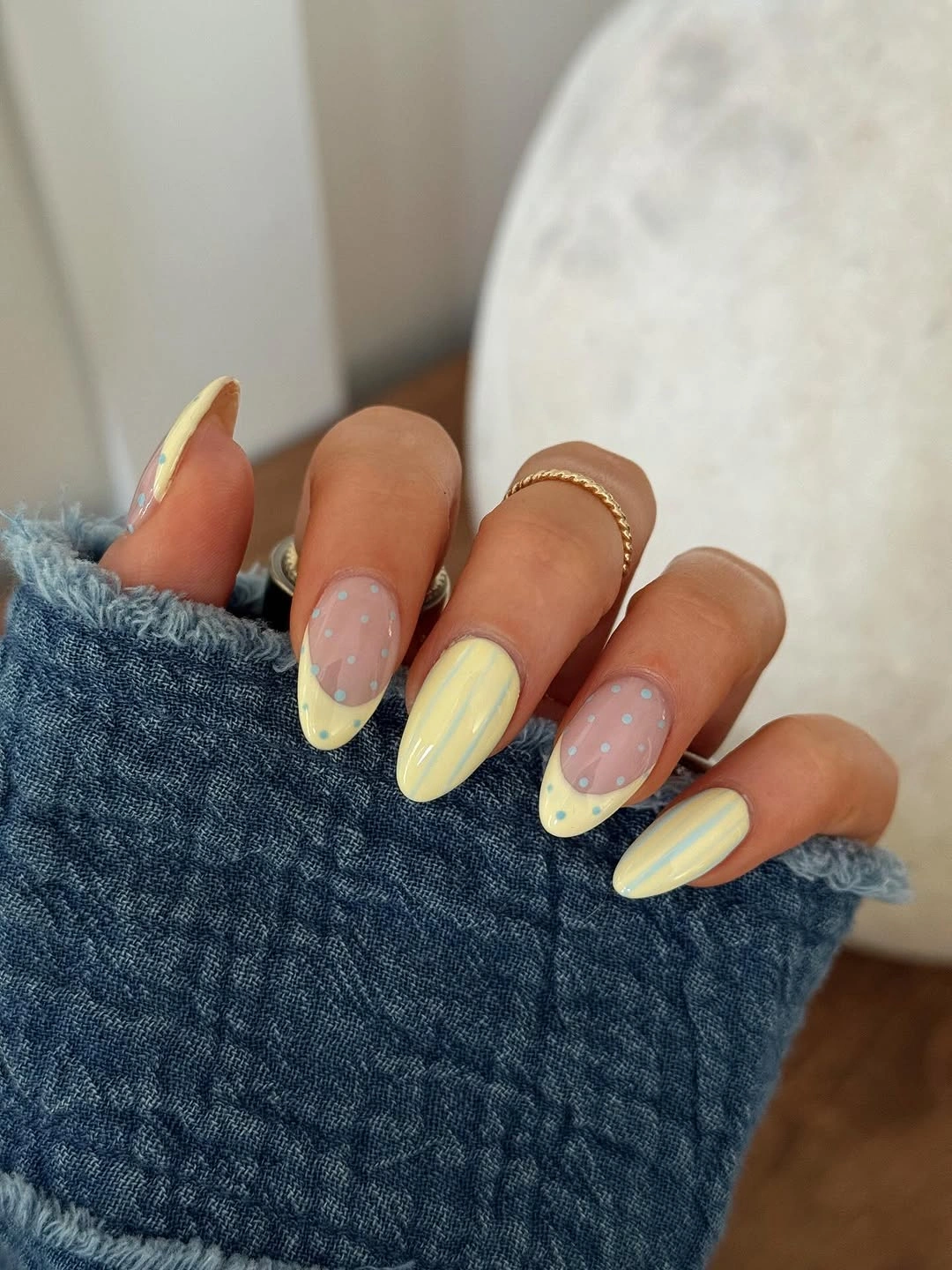 august nails color 2026 Soft Butter Yellow Nails with Delicate Polka Dot Charm