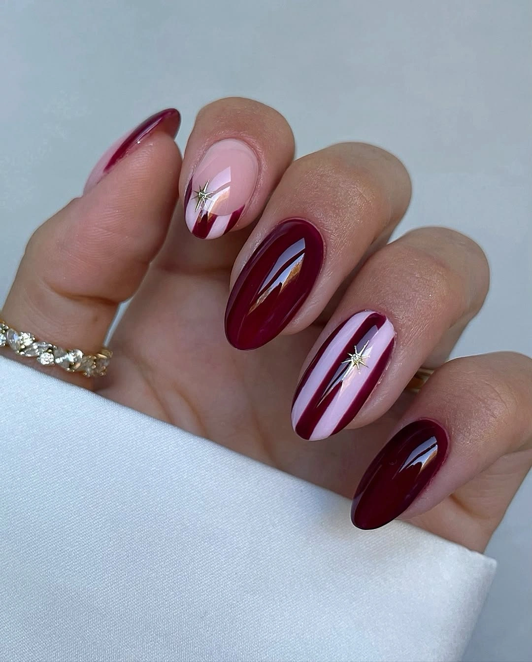 august nails ideas 2026 Rich Burgundy Elegance with Chic Graphic Accents