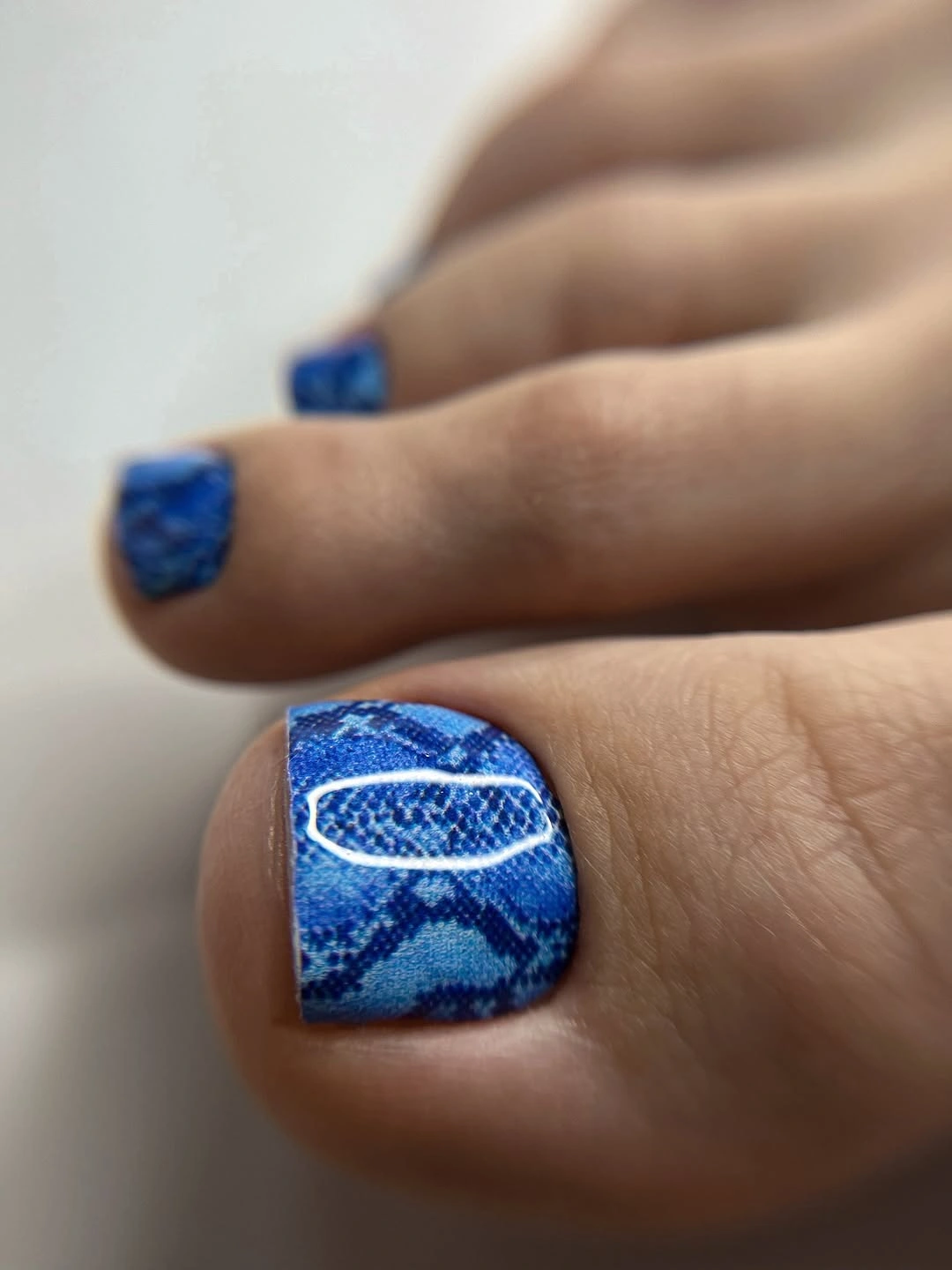 august pedicure nails ideas 2026 Ocean Blue Snake Print for a Bold Coastal Mood