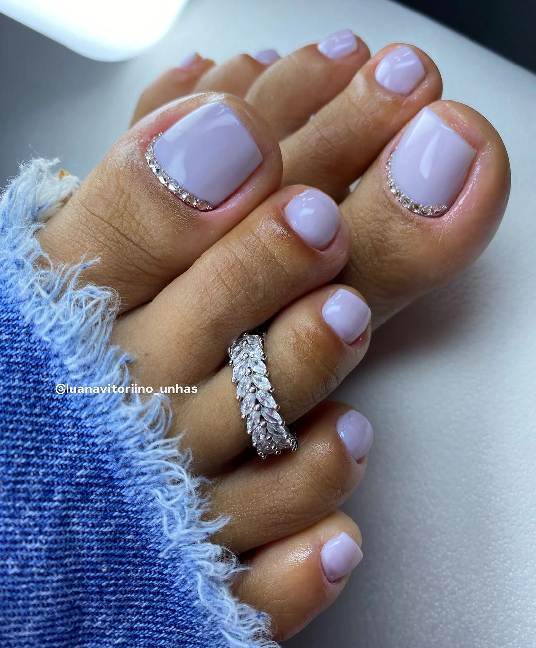 august pedicure nails ideas 2026 Milky Lavender with Crystal Cuticle Details