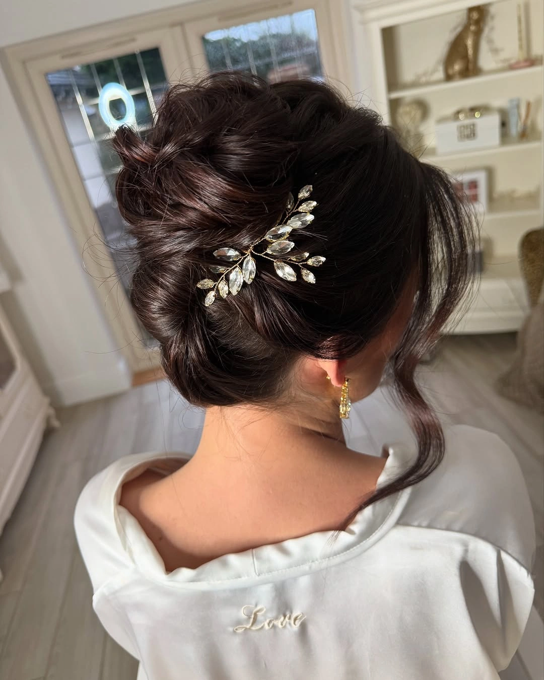 bridesmaid hairstyling Elegant Textured Updo with Crystal Leaf Hairpiece