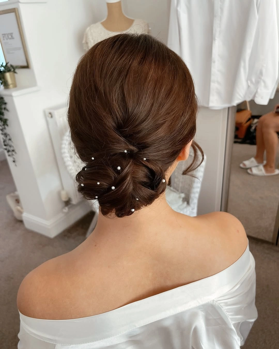 bridesmaid hairstyling Soft Low Chignon with Delicate Pearl Details