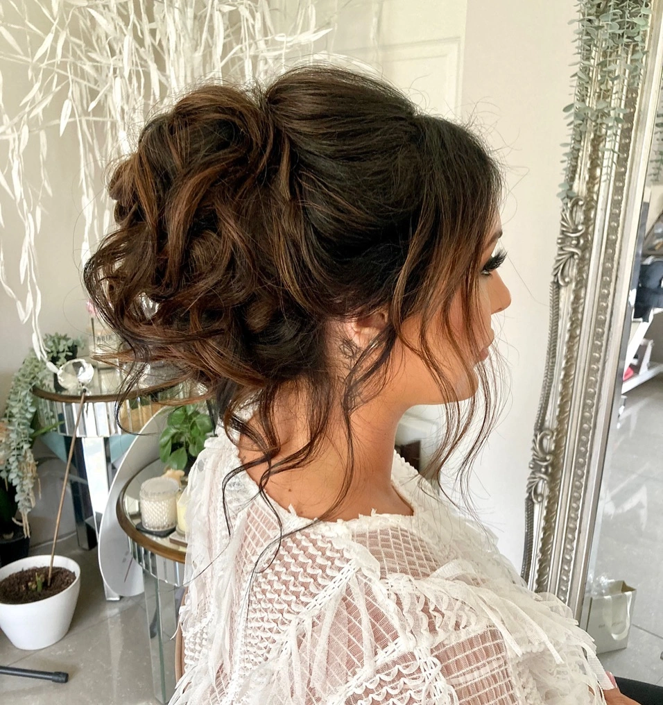 bridesmaid hairstyling Romantic High Textured Bun with Soft Curly Tendrils