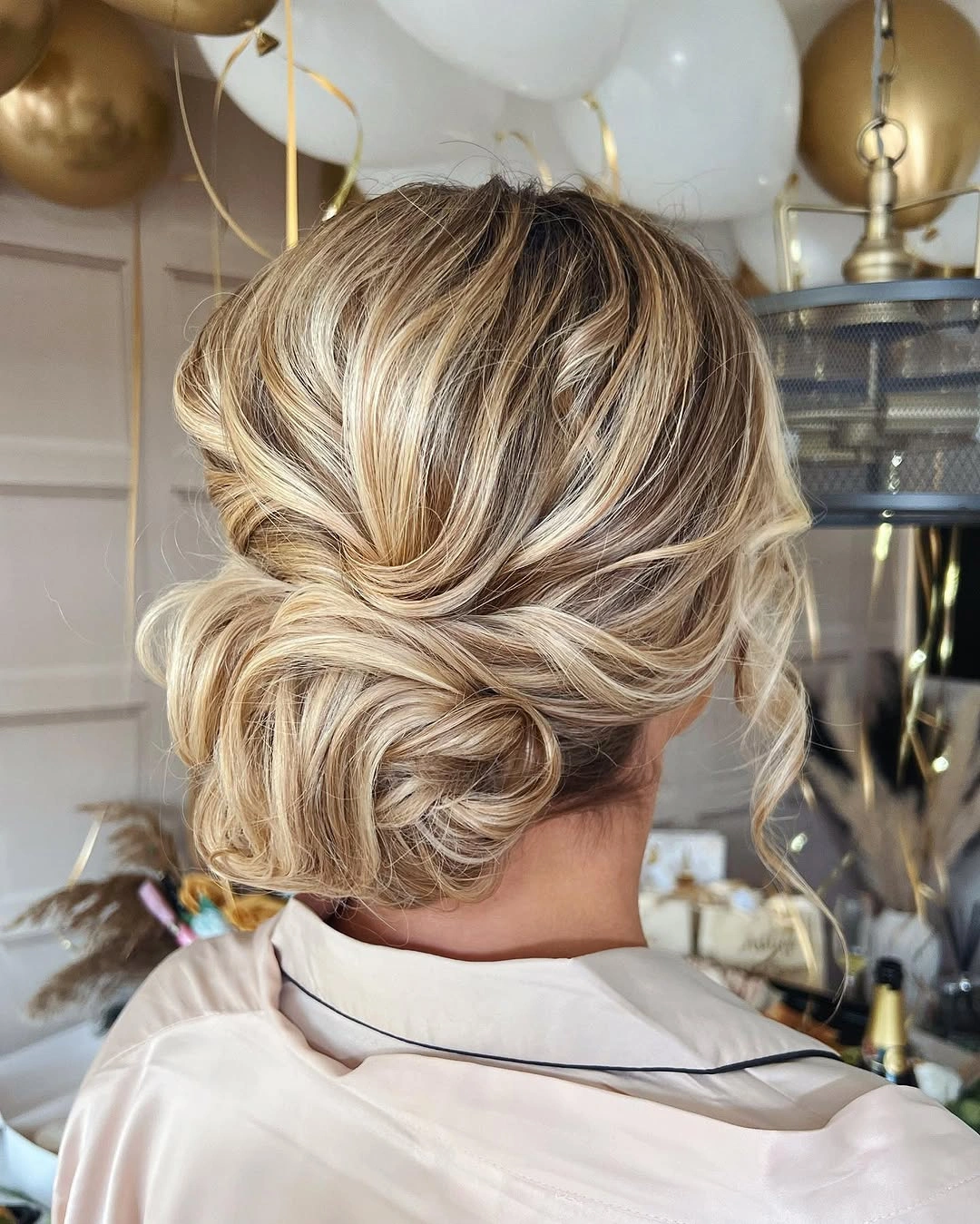 bridesmaid hairstyling Dimensional Blonde Twisted Low Bun with Soft Volume