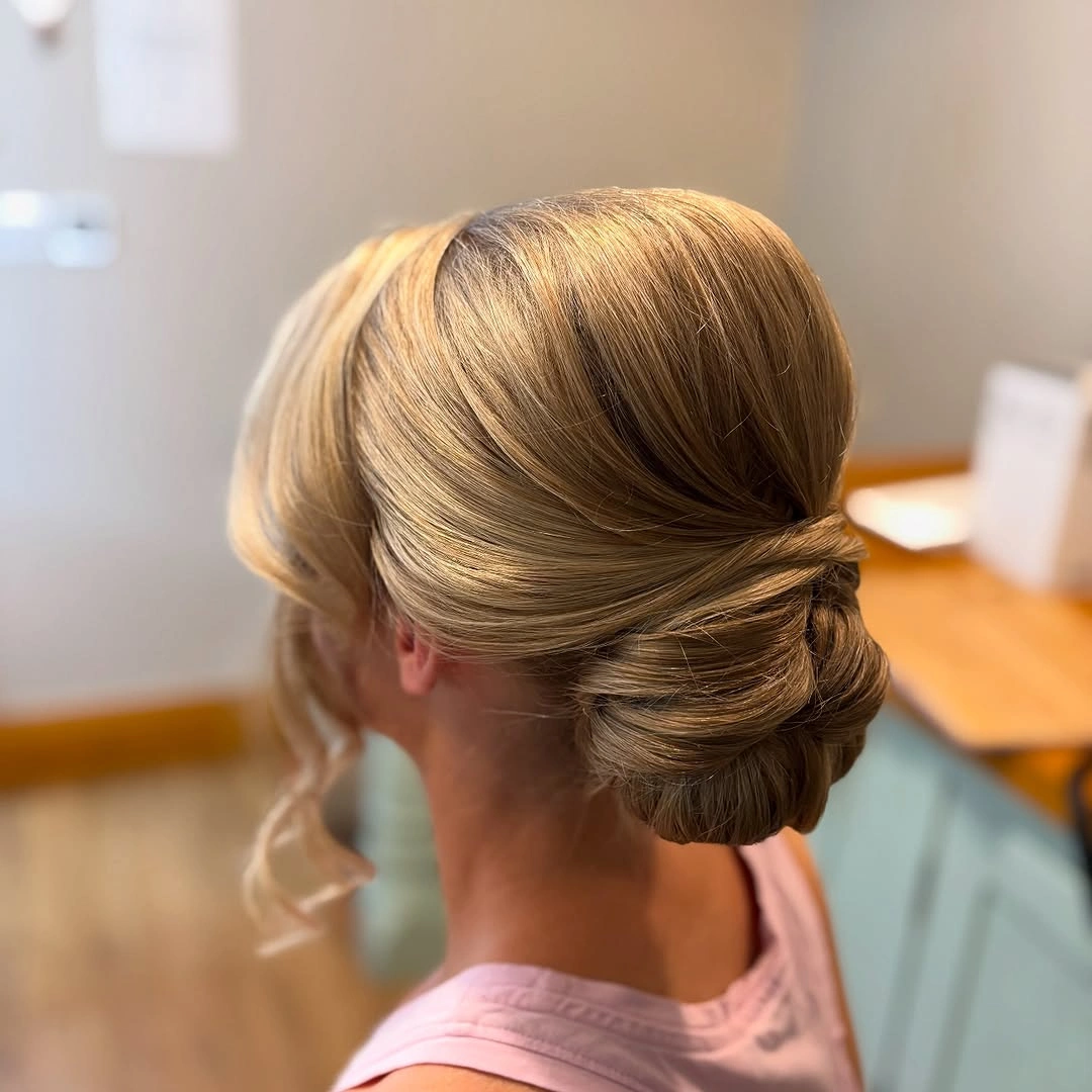 bridesmaid hairstyling Refined Low Side Bun with Sleek Sophistication