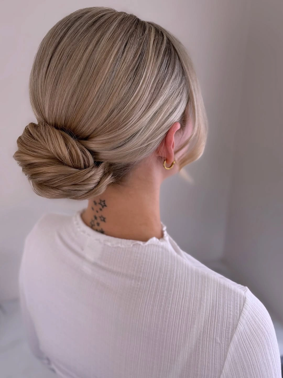 bridesmaid hairstyling Minimalist Low Chignon with Sleek Satin Finish