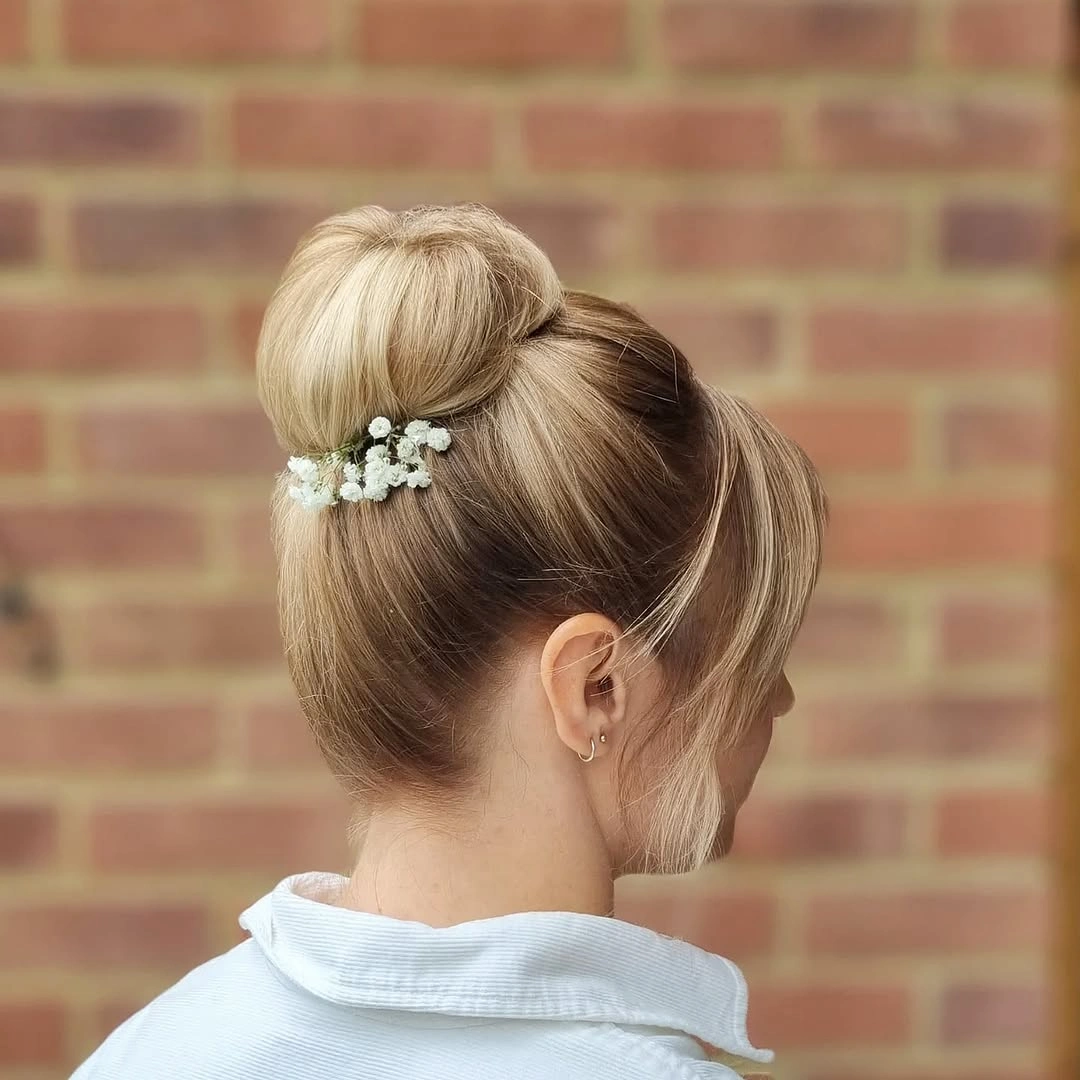 bridesmaid hairstyling Classic High Bun with Soft Face-Framing Layers