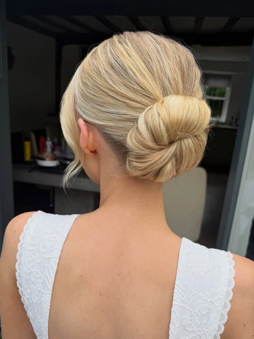bridesmaid hairstyling Minimalist Sleek Bridal Bun with a Contemporary Finish