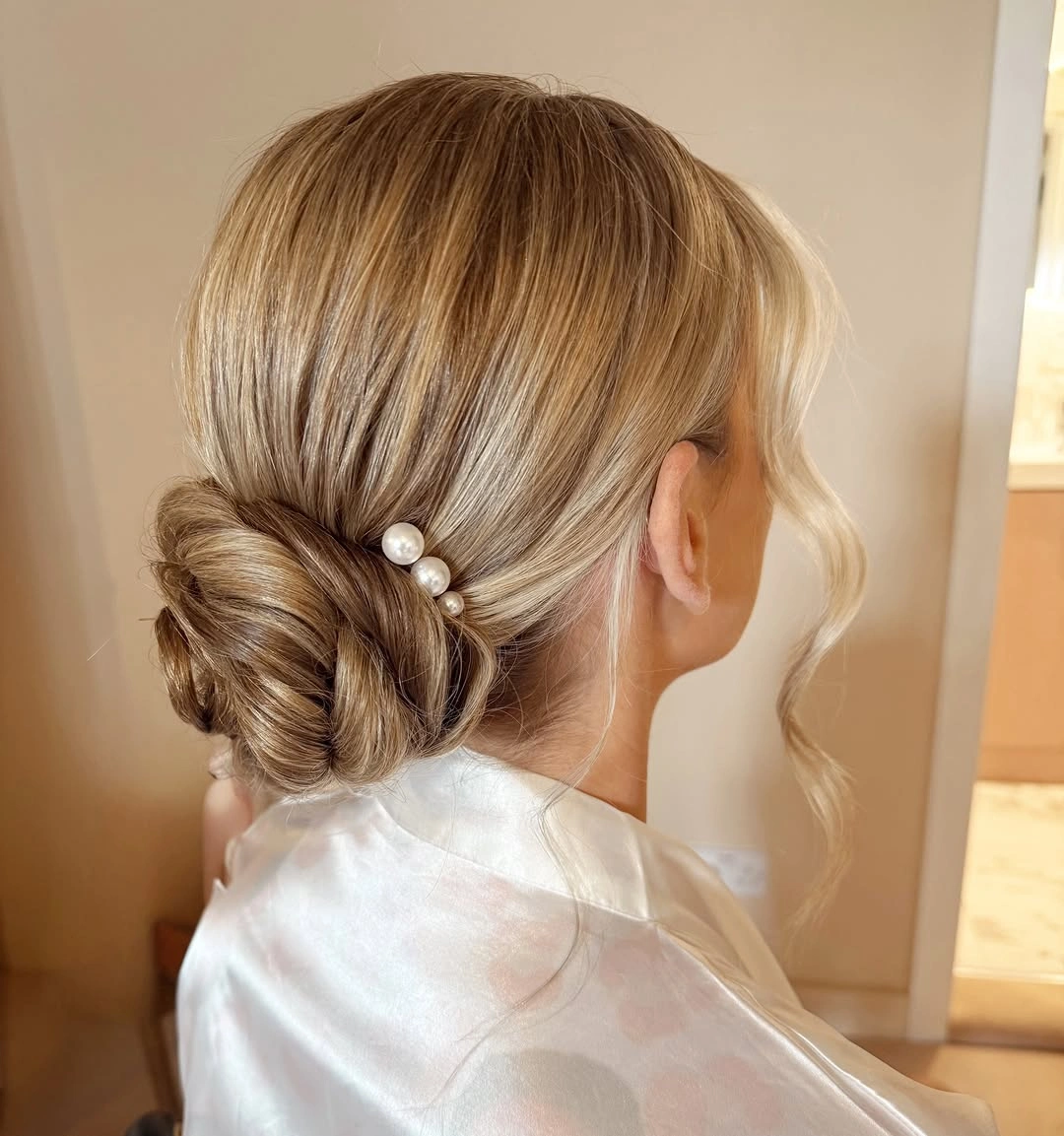 bridesmaid hairstyling Low Textured Bridal Bun with Pearl Accents