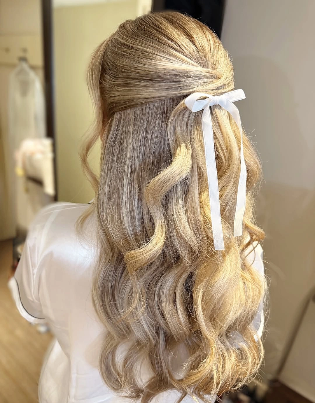 bridesmaid hairstyling Ribbon-Tied Half-Up Hairstyle with Soft Blonde Waves