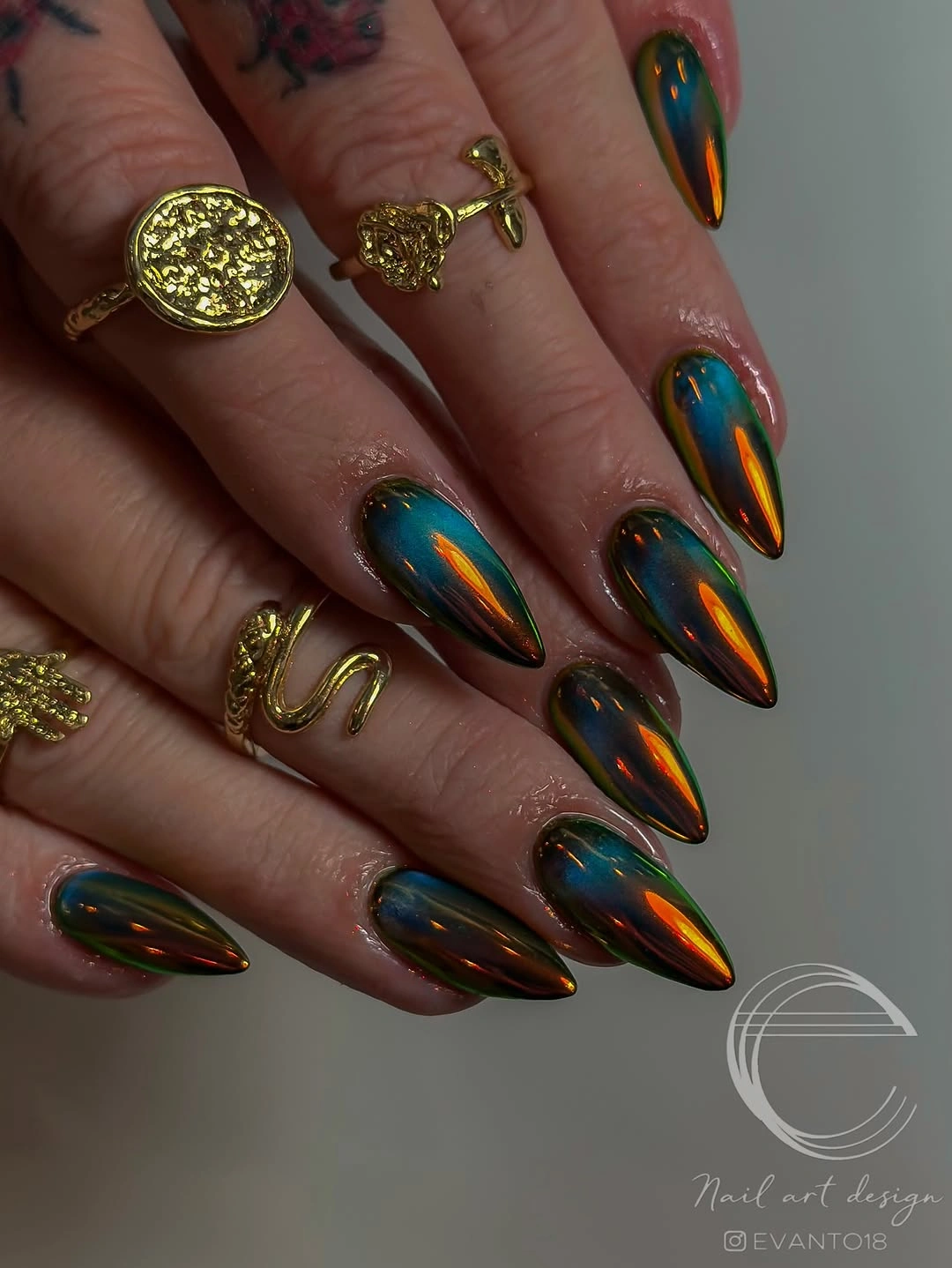 oil slick chrome almond nails in autumn tones