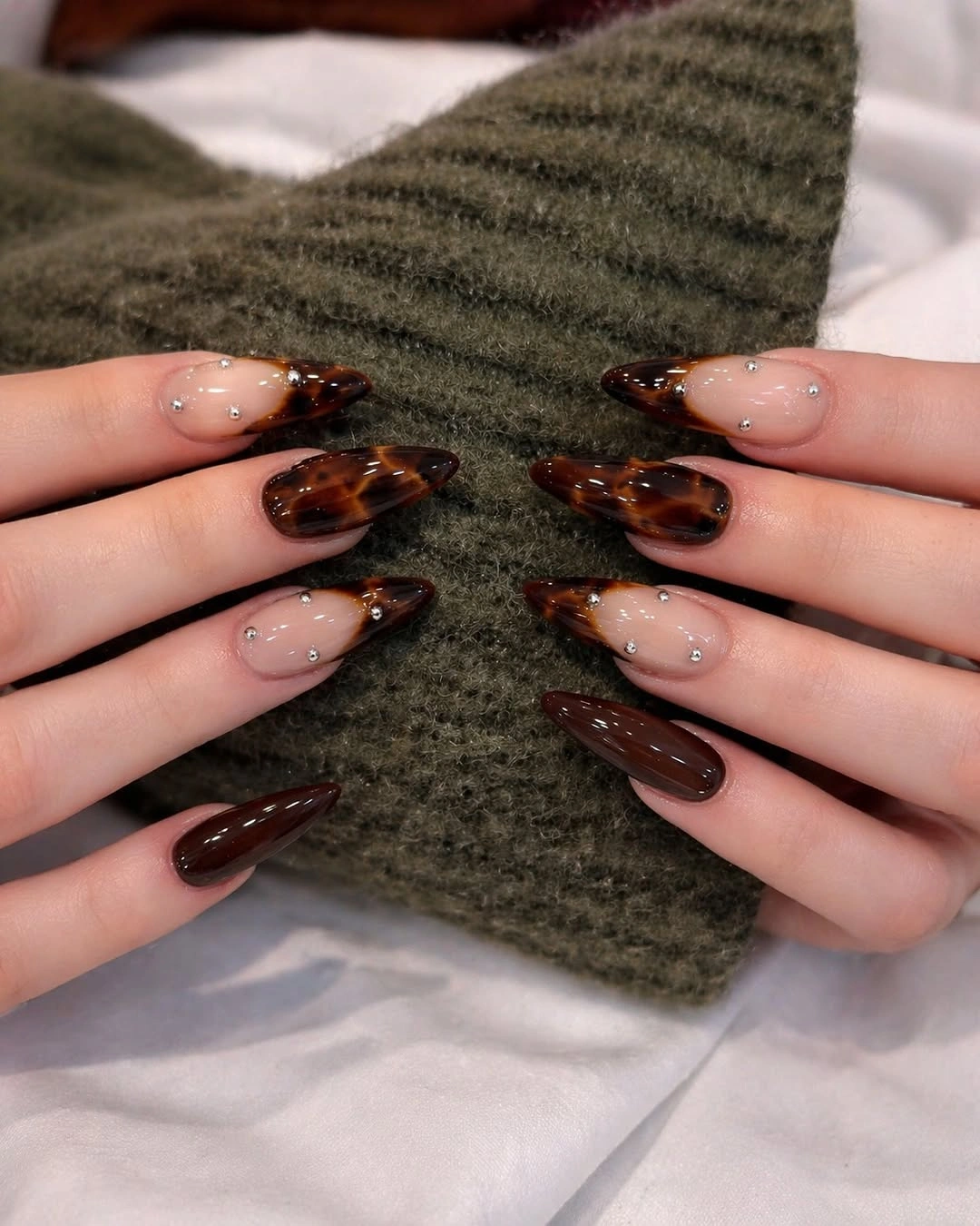 tortoiseshell brown almond nails with sparkle accents