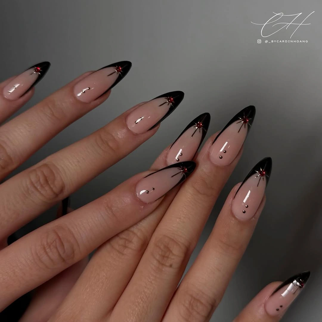 black almond French tips with red gem accents