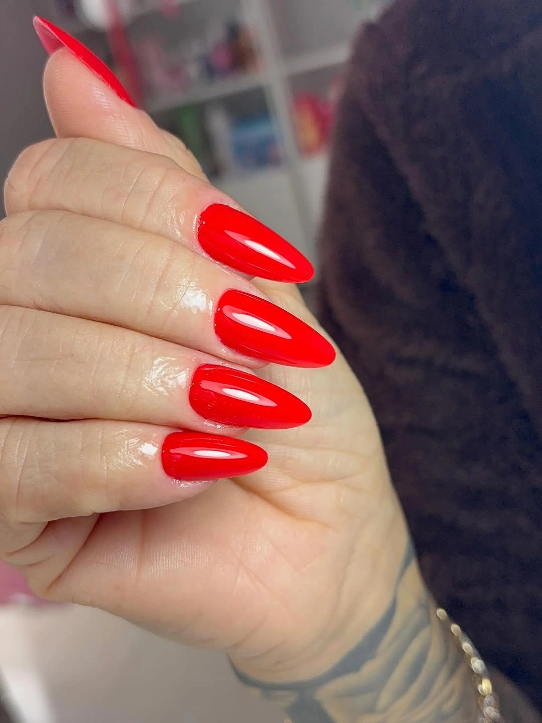glossy scarlet red almond nails