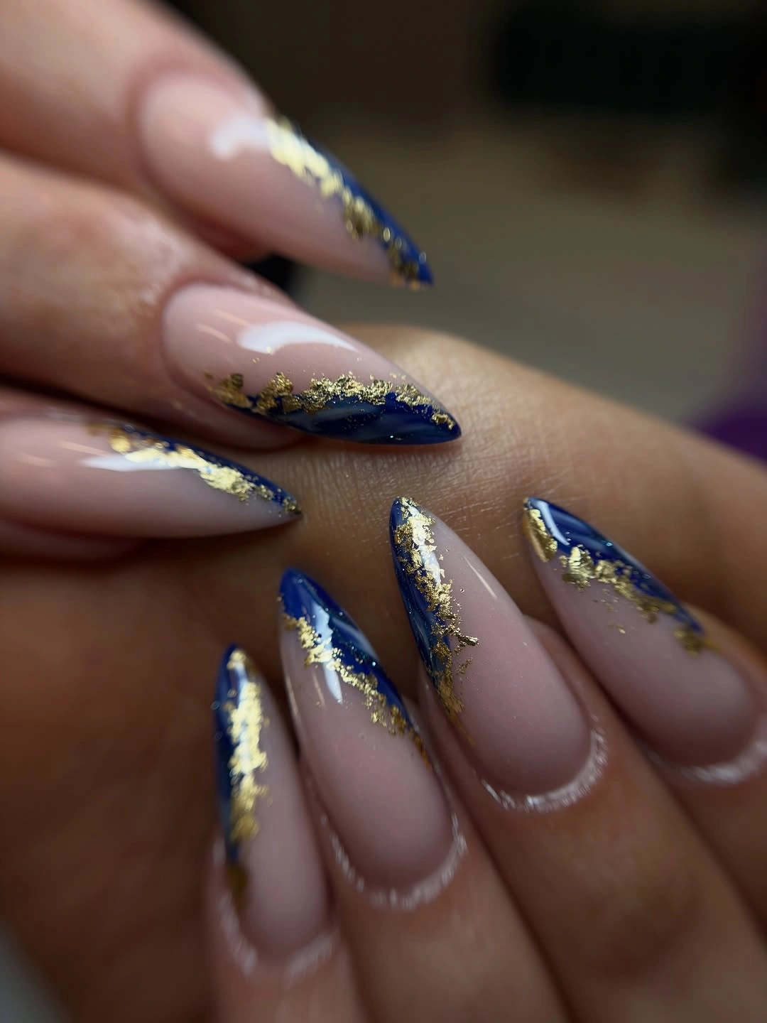 nude almond nails with navy gold diagonal art