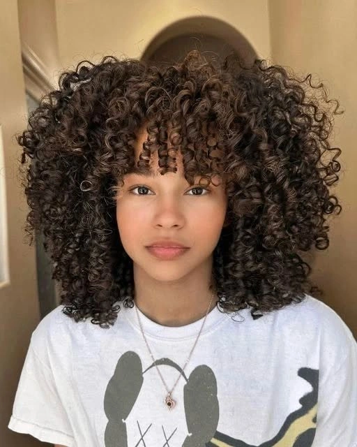 fall hair colors for black women 2026 Chocolate Brown Curly Bob With Playful Fringe
