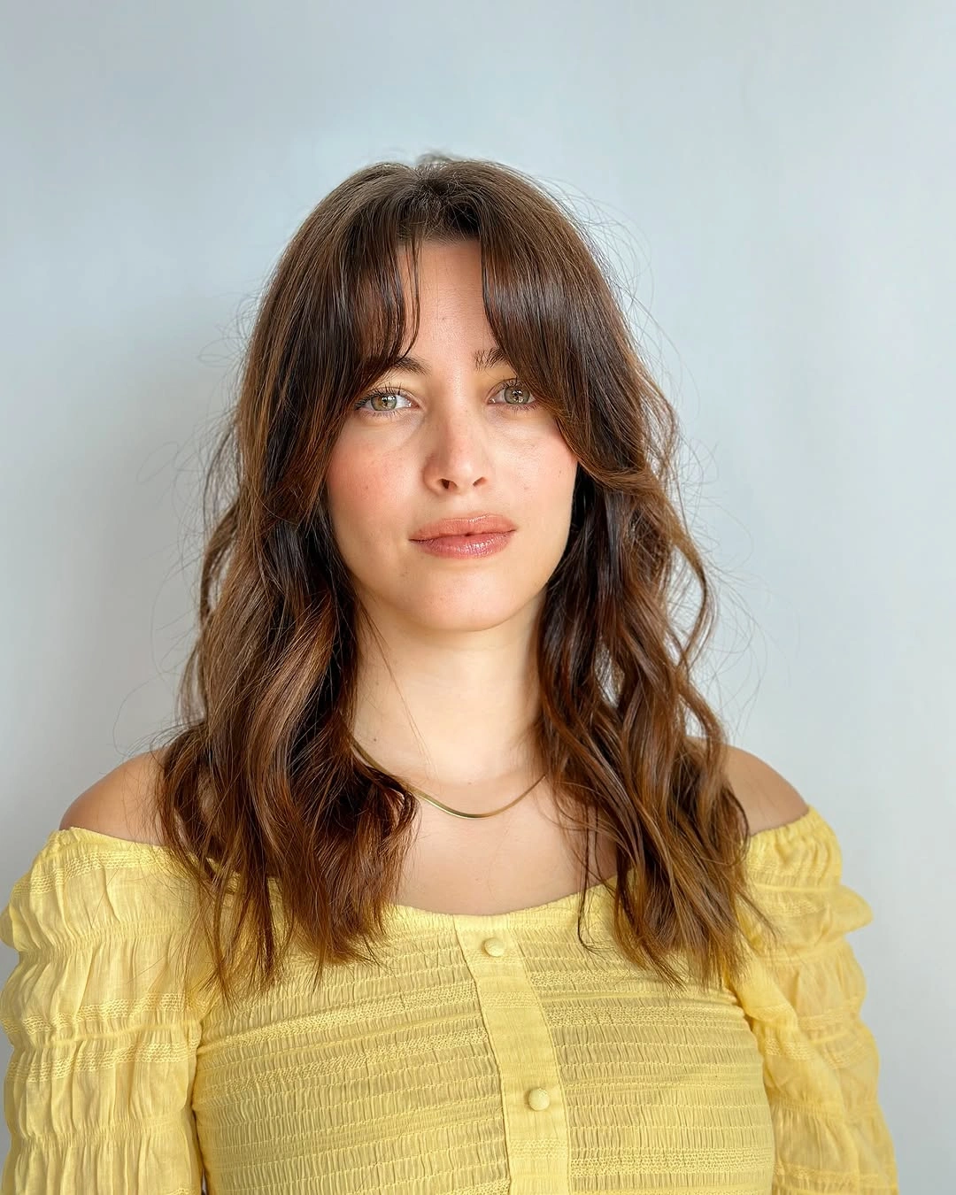 fall hairstyles 2026 Effortless Curtain Bangs With Soft Shoulder-Length Waves