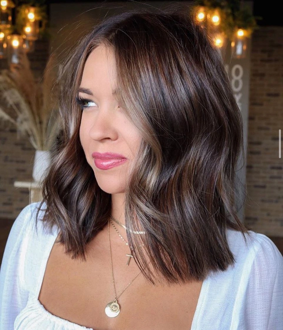 fall hairstyles 2026 Soft Brunette Lob With Bright Money Piece Highlights