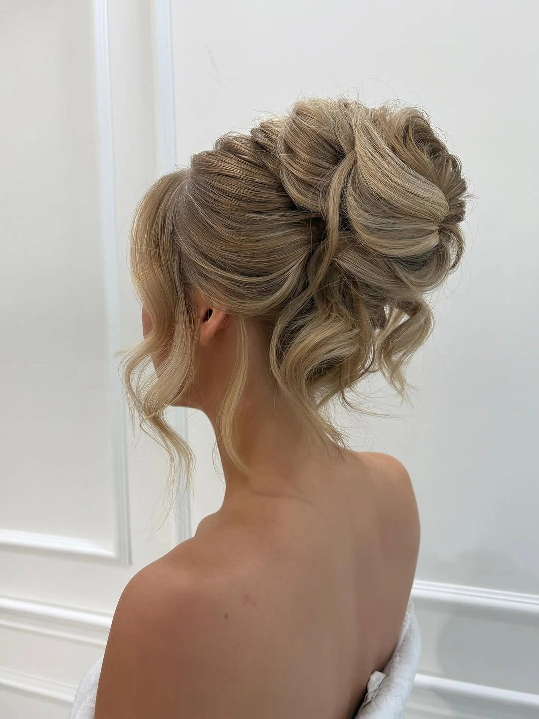 Fall hairstyles for office 2026 Romantic Textured High Bun with Soft Face-Framing Waves