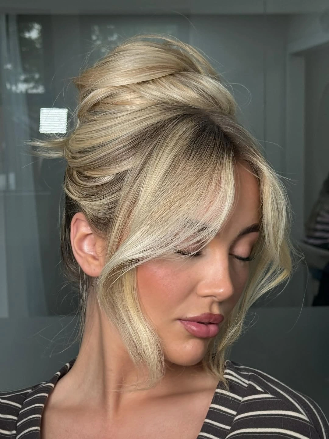 Fall hairstyles for wedding guests 2026 Elegant French Twist with Soft Curtain Bangs